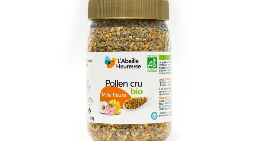 Un pot de pollen cru mille fleurs bio de L'Abeille Heureuse, rempli de granules dorés et orangés.